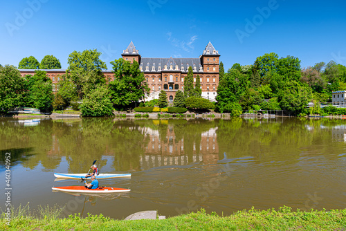 Turin, Italy. May 12th, 2021. View of the Valentino Castle from the Po river with two people canoeing.