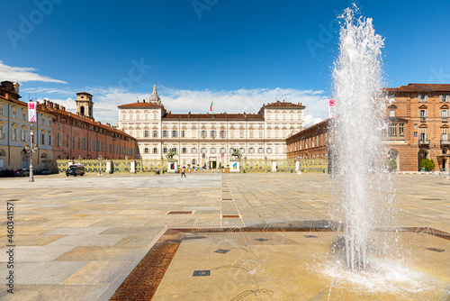 Turin, Italy. May 12th, 2021. View of the Royal Palace and Piazza Castello square in the historic center of the city with the fountain and some people walking around.