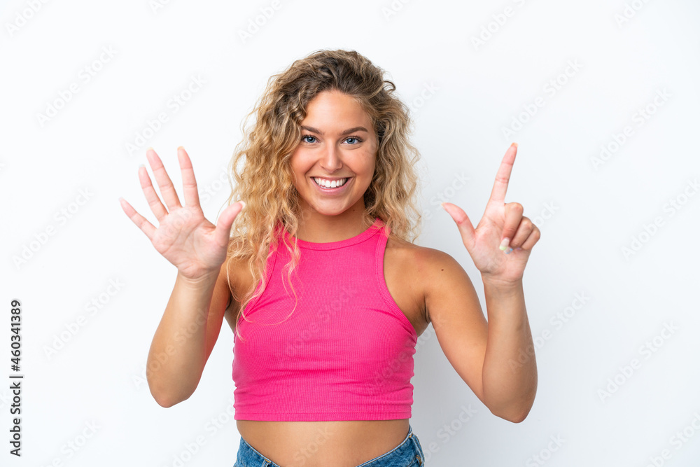 Fototapeta premium Girl with curly hair isolated on white background counting seven with fingers