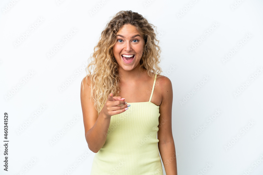 Girl with curly hair isolated on white background surprised and pointing front Girl with curly hair isolated on white background surprised and pointing front