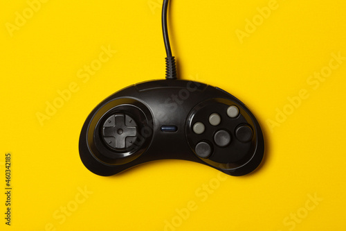 black six-button gamepad against a yellow background