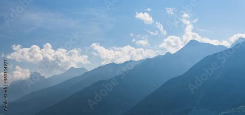 Gradations of distant mountains with blue partly cloudy sky