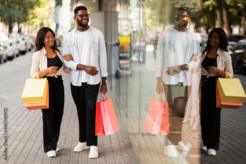 Beautiful black couple walking with shopping bags