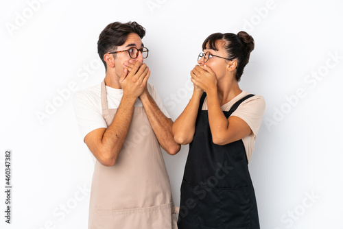 Restaurant mixed race waiters isolated on white background covering mouth with hands for saying something inappropriate