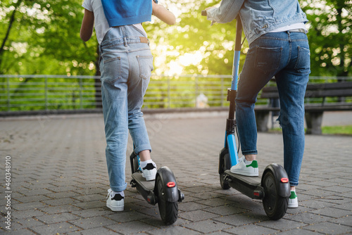 Mother and daughter riding electric scooters