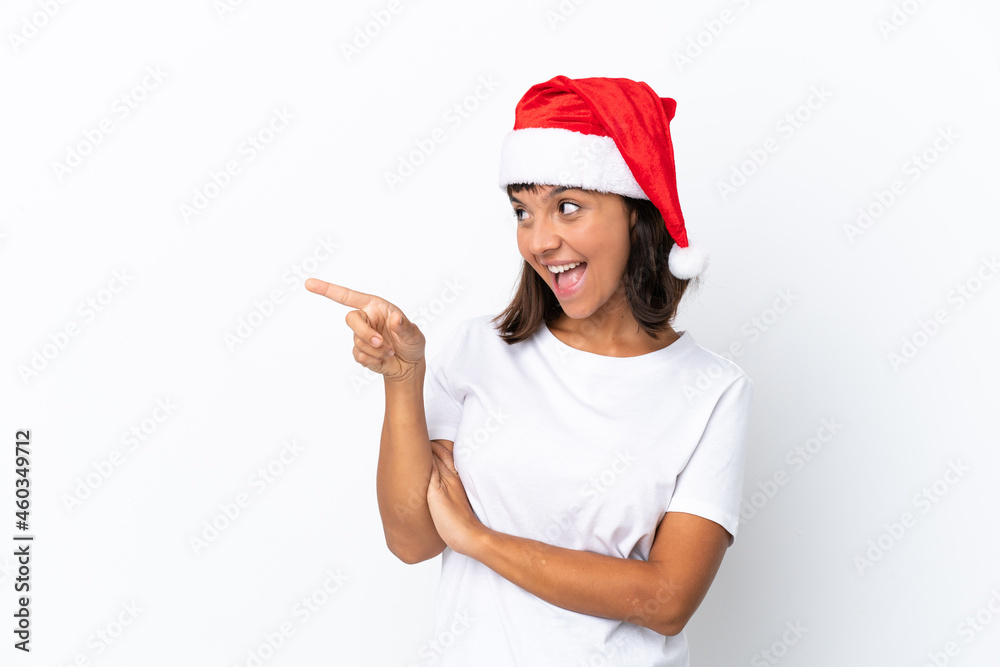 Young mixed race woman celebrating Christmas isolated on white background pointing finger to the side and presenting a product Young mixed race woman celebrating Christmas isolated on white background pointing finger to the side and presenting a product