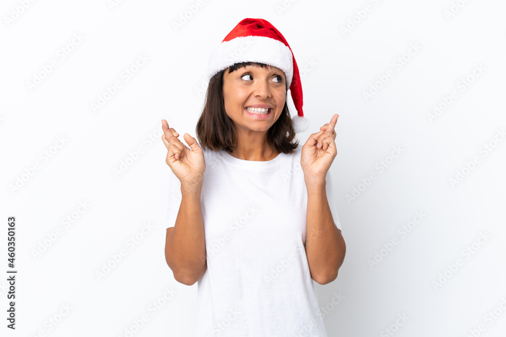 Young mixed race woman celebrating Christmas isolated on white background with fingers crossing Young mixed race woman celebrating Christmas isolated on white background with fingers crossing