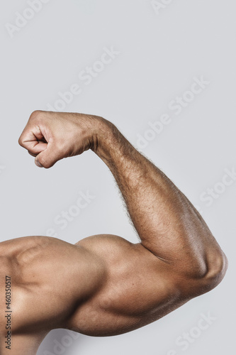 Muscular arm of young bodybuilder