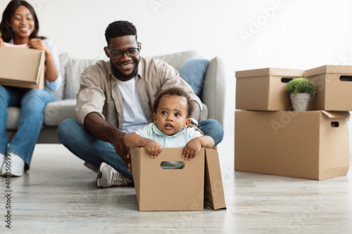 Happy black family celebrating moving day in new apartment