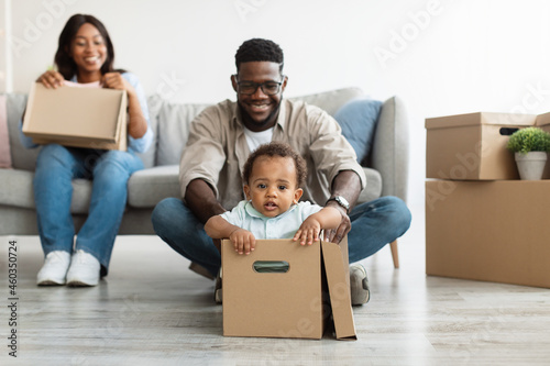 Excited black family celebrating moving day in new apartment