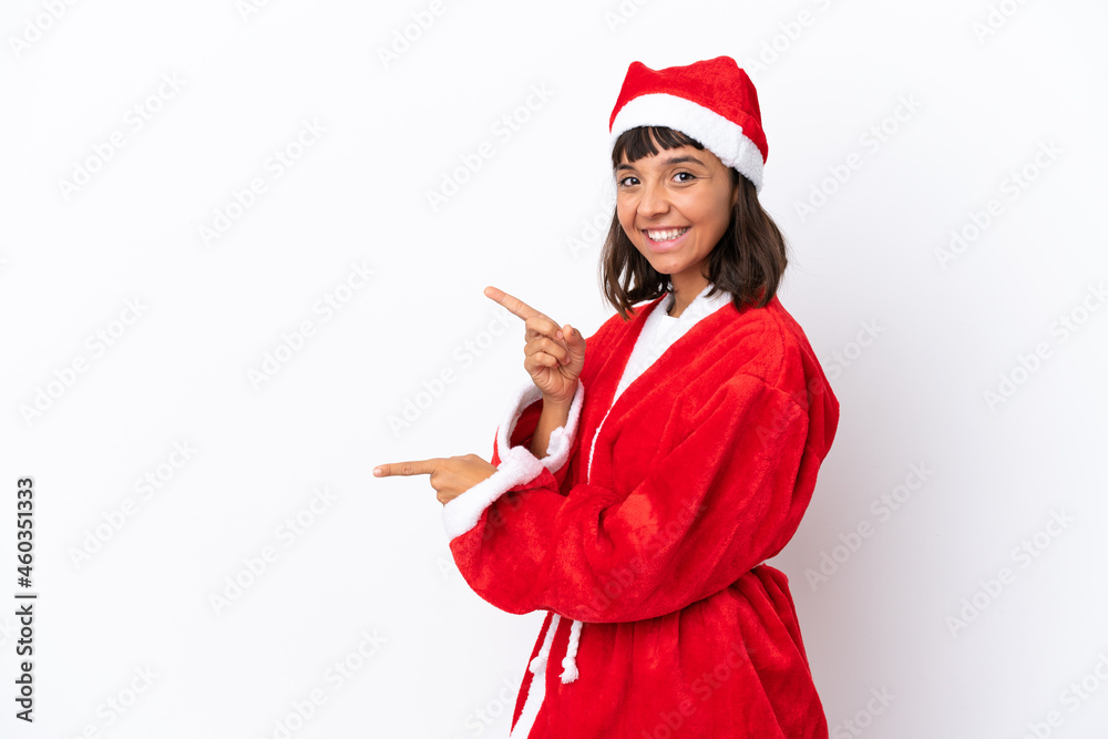 Young mixed race woman disguised as Santa Claus isolated on white background pointing finger to the side and presenting a product Young mixed race woman disguised as Santa Claus isolated on white background pointing finger to the side and presenting a product
