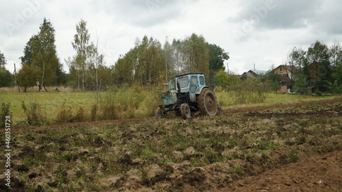 tractor ploughs arable land, an agricultural concept