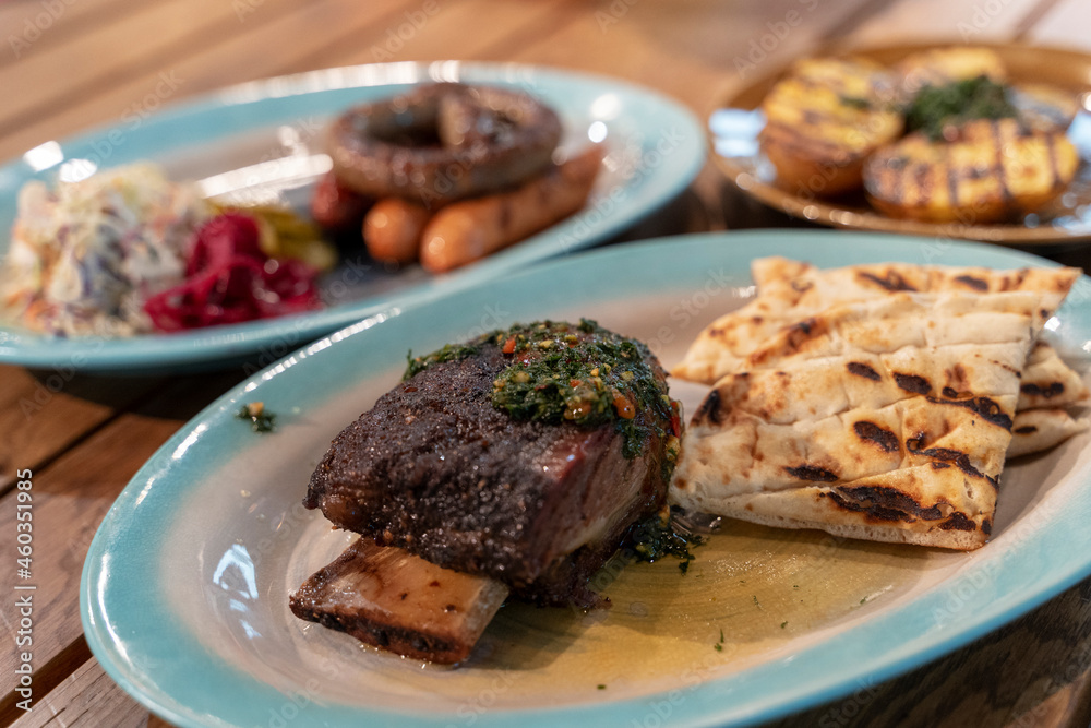 assorted dishes with potatoes, baked ribs and sausages, dishes in the restaurant assorted dishes with potatoes, baked ribs and sausages, dishes in the restaurant