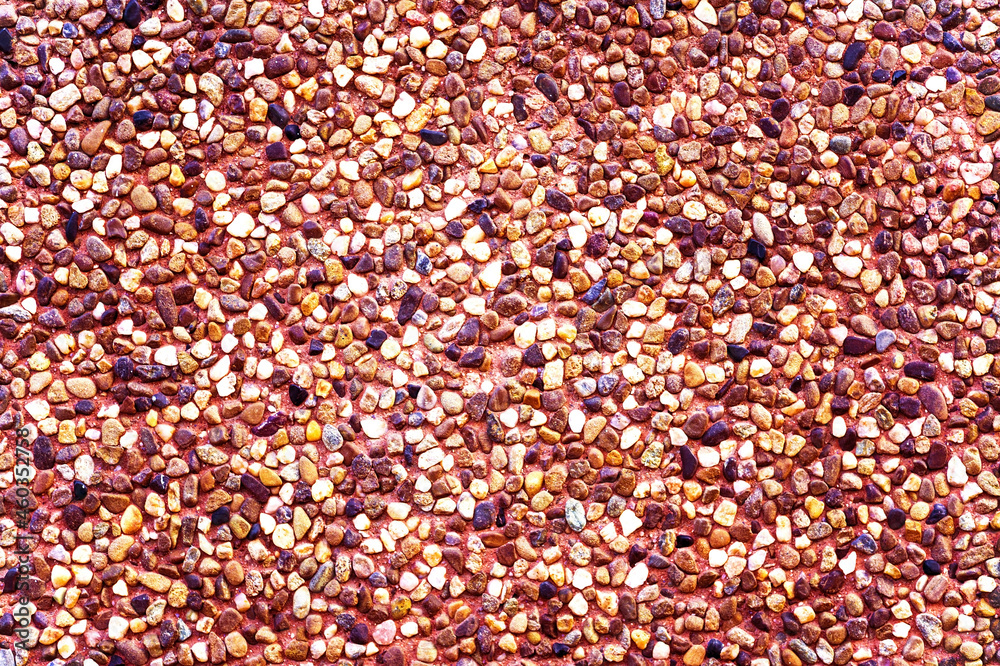 texture with multi-colored stones. objects of different colors on a green background. multicolored pebbles texture with multi-colored stones. objects of different colors on a green background. multicolored pebbles
