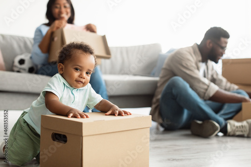 Happy African American family relocating to new apartment