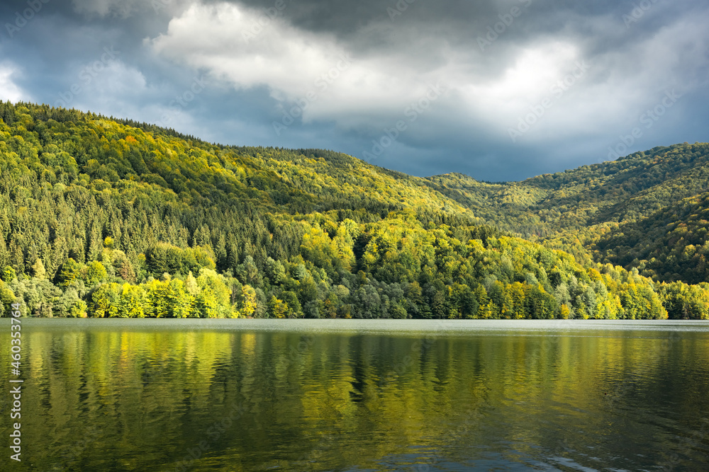 Picturesque landscape with clear lake and autumn forest on his coast. Tereblia-Ritske Reservoir (Vilshanske) on Tereblia river, Transcarpathian region, Ukraine