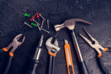Many different tools for repair work on a black background