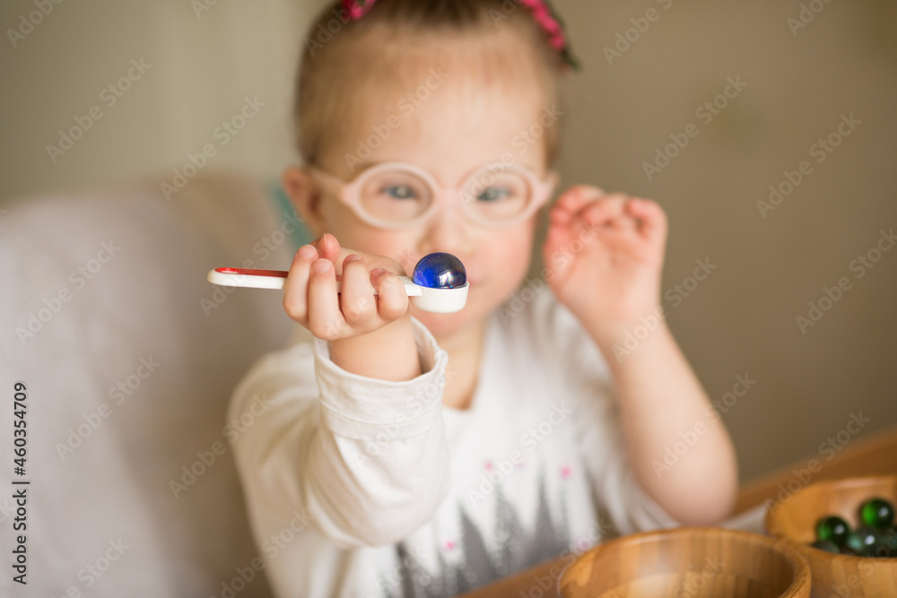 a girl with Down syndrome are trained at Montessori a girl with Down syndrome are trained at Montessori