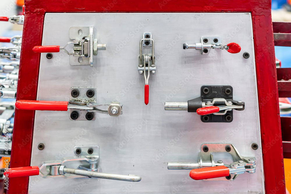 Fototapeta premium Various type metal toggle clamp or quick lock e.g. pull push latch vertical horizontal handle clamp etc. for manufacturing process in industrial