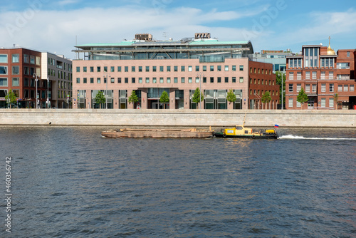 Photography A small ship pushes a large barge along the Moscow River along the Prechistenska