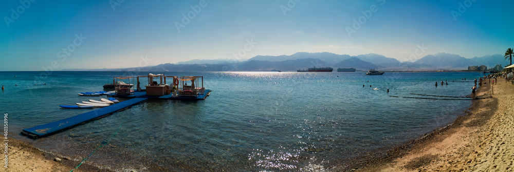 Panorama. Floating resting island and swimming area on sandy beach of the Red Sea during serene tropical day, Middle East. Concept of bliss vacation