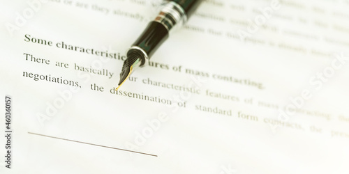 designed black fountain pen on bank paper document macro