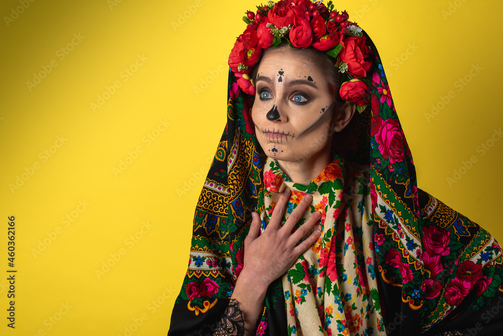 Kalavera Katrina girl shows various emotional gestures to the body, face, in a headscarf, on a yellow background, looks and sideways, a place for an inscription. Dia-de -los -muertos. Day of death.