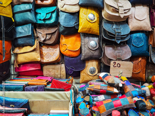Handmade colourful leather bags and purses on display at traditional souk - street market in Morocco