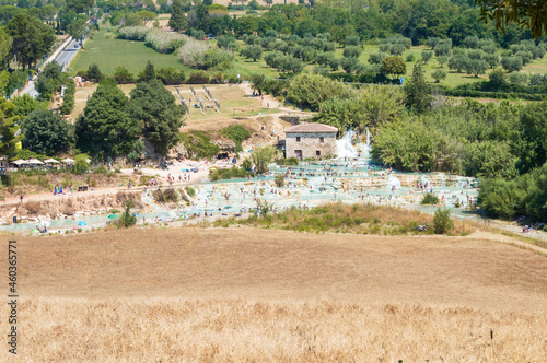 The gorgeous natural thermal bath of Saturnia. Warm water spills out of the rock creating a waterfall with spontaneous ponds, the "Cascate del Molino" in Tuscany, Italy