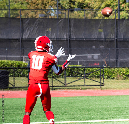 Football receiver about to catch the ball for a touchdown