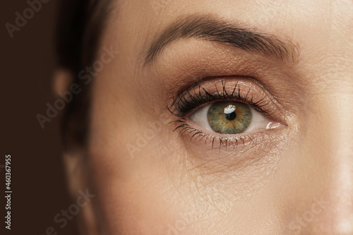 Fototapeta Naklejka Na Ścianę i Meble -  Aged female eye with wrinkled skin