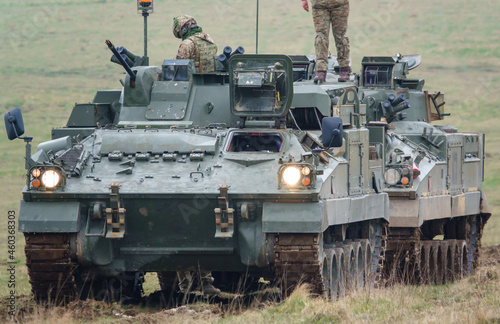 british army FV512 warrior MRV preparing to tow a stricken warrior FV510 light infantry fighting vehicle tank on Salisbury Plain, Wiltshire