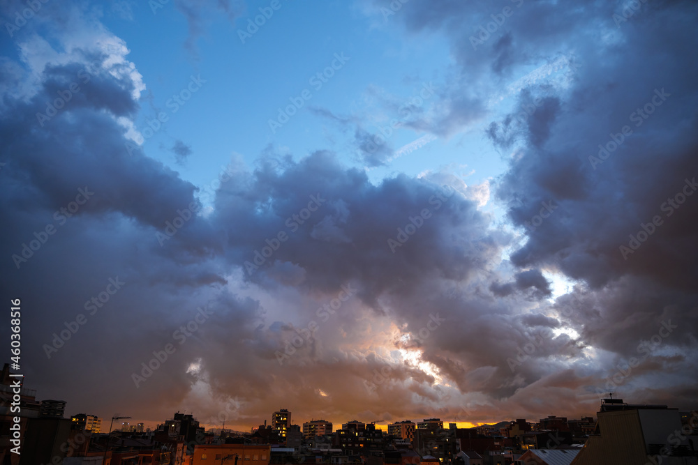 Blue sky at sunset twilight over city lights with heavy clouds