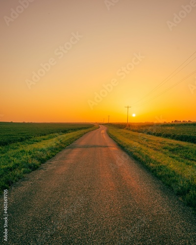Obraz na płótnie Sunset over a rural road with fields, near Route 66 in Towanda, Illinois w salonie