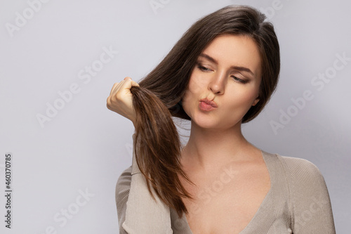 Quadro su tela Young woman is upset with a bad condition of her hair