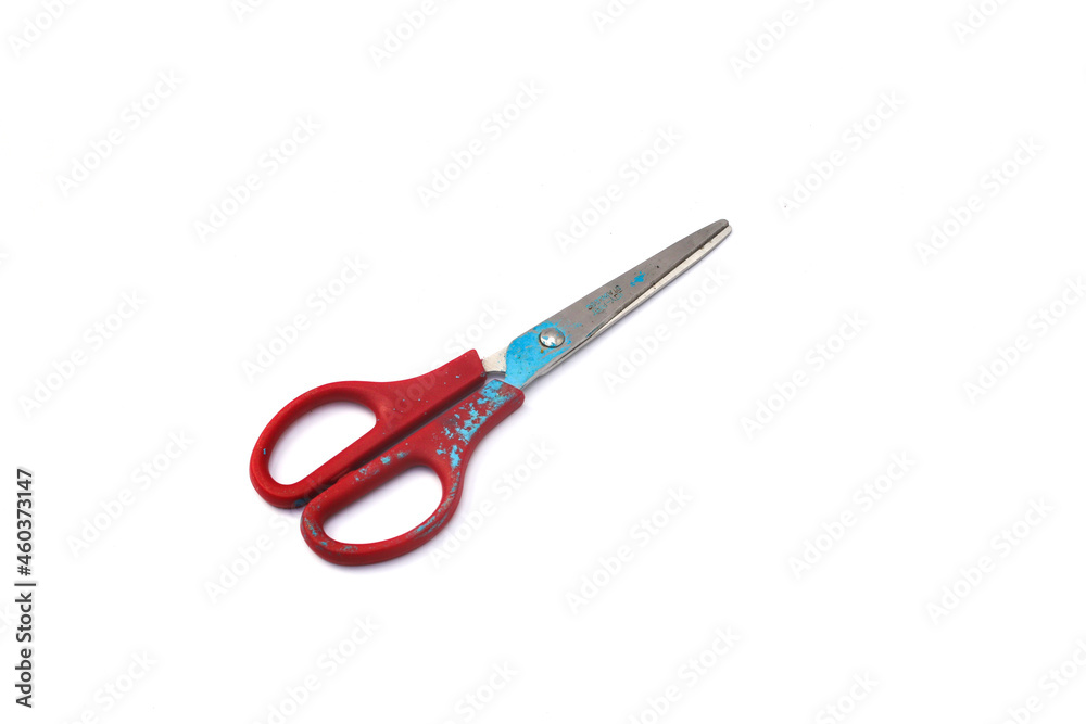 Red used scissors with paint splatter isolated on white background