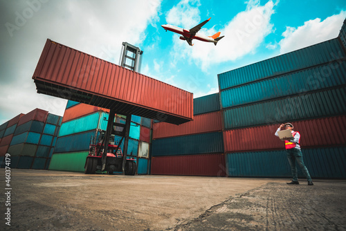 Fotobehang Cargo container for overseas shipping in shipyard with airplane in the sky