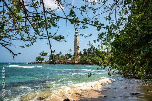 Beautiful beach and White lighthouse Dondra in Sri Lanka. View from the beach. photo