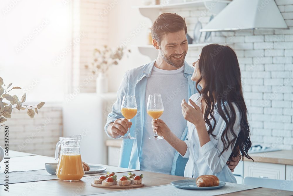 Beautiful young couple enjoying breakfast together while spendin