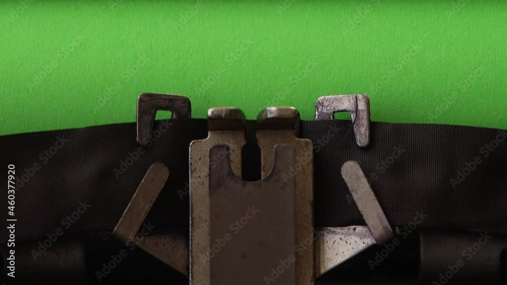 Typing on retro typewriter on a green page. Chromakey.