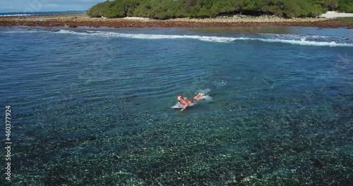 Aerial view of surfers on sea waves, Maldives. High quality 4k footage photo