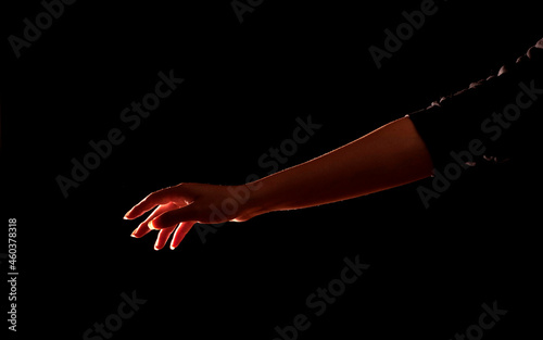 woman reaching with arm, rim light