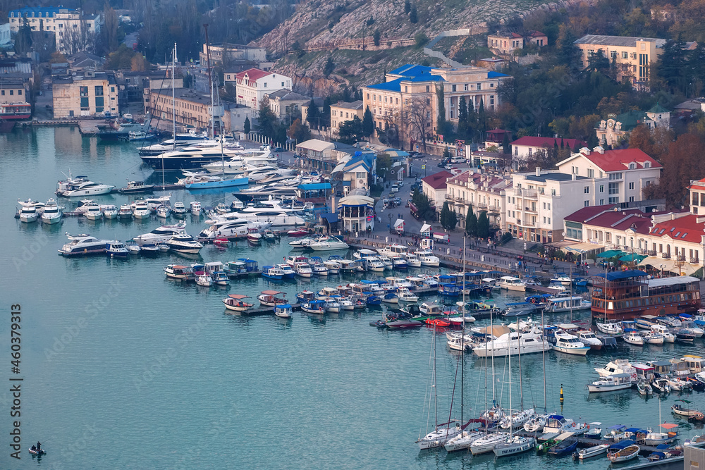 Balaklava, Crimea, Russia - 31 October, 2018: A city by the sea. Yachts and boats are in the port. Top view of the city.