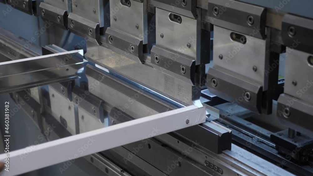 Bending metal machine. Plate steel worker hands put of industrial bending machine metal press industry equipment factory. Worker holds steel sheet on bending machine forms steel products. Metalworking Bending metal machine. Plate steel worker hands put of industrial bending machine metal press industry equipment factory. Worker holds steel sheet on bending machine forms steel products. Metalworking
