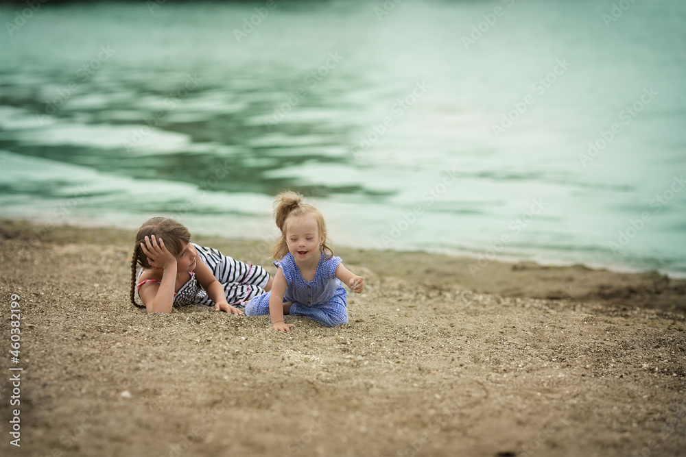 sisters lovingly embraces his sister with Down syndrome sisters lovingly embraces his sister with Down syndrome