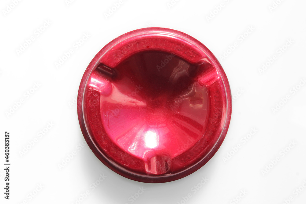 Vintage red aluminum empty ashtray from above, isolated on a white background