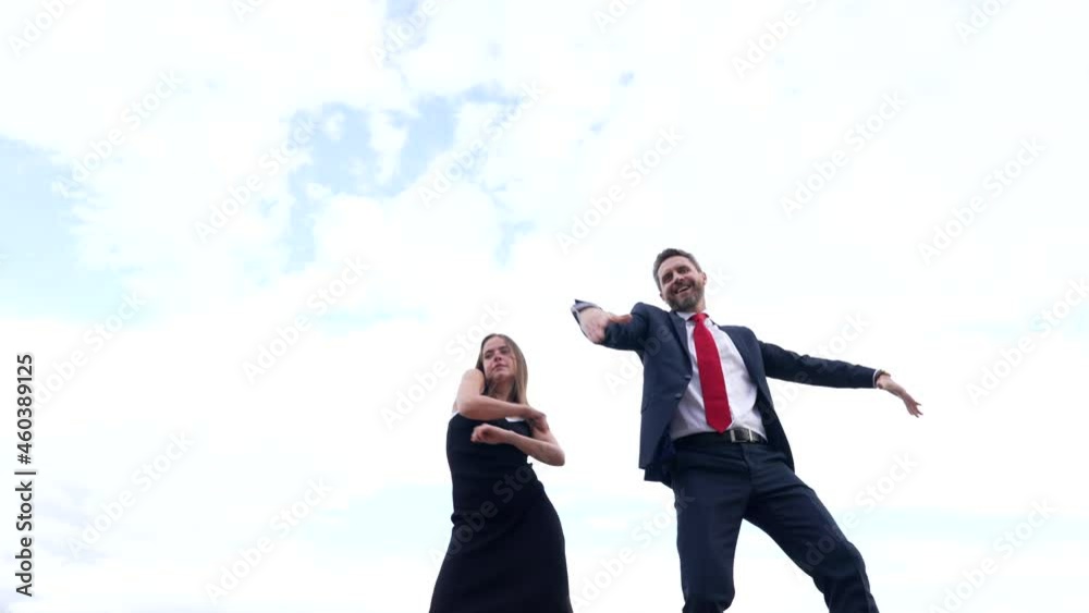 Happy professional couple of ambitious man and woman dance in sky, dancing Happy professional couple of ambitious man and woman dance in sky, dancing