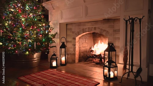cozy fireplace at home with Christmas tree in the background photo