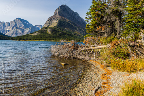 The Rocky Shoreline of Swiftcurrent Lake with Grinnel Point, Glacier National Park, Montana, USA photo