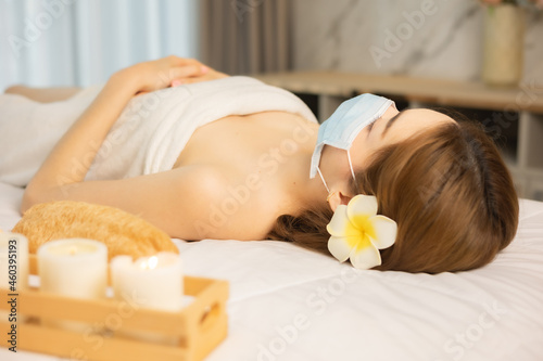 New normal lifestyle concept.Asian Beautiful, young and healthy woman in spa salon. Massage treatment spa room Traditional medicine and healing concept.woman with face mask.